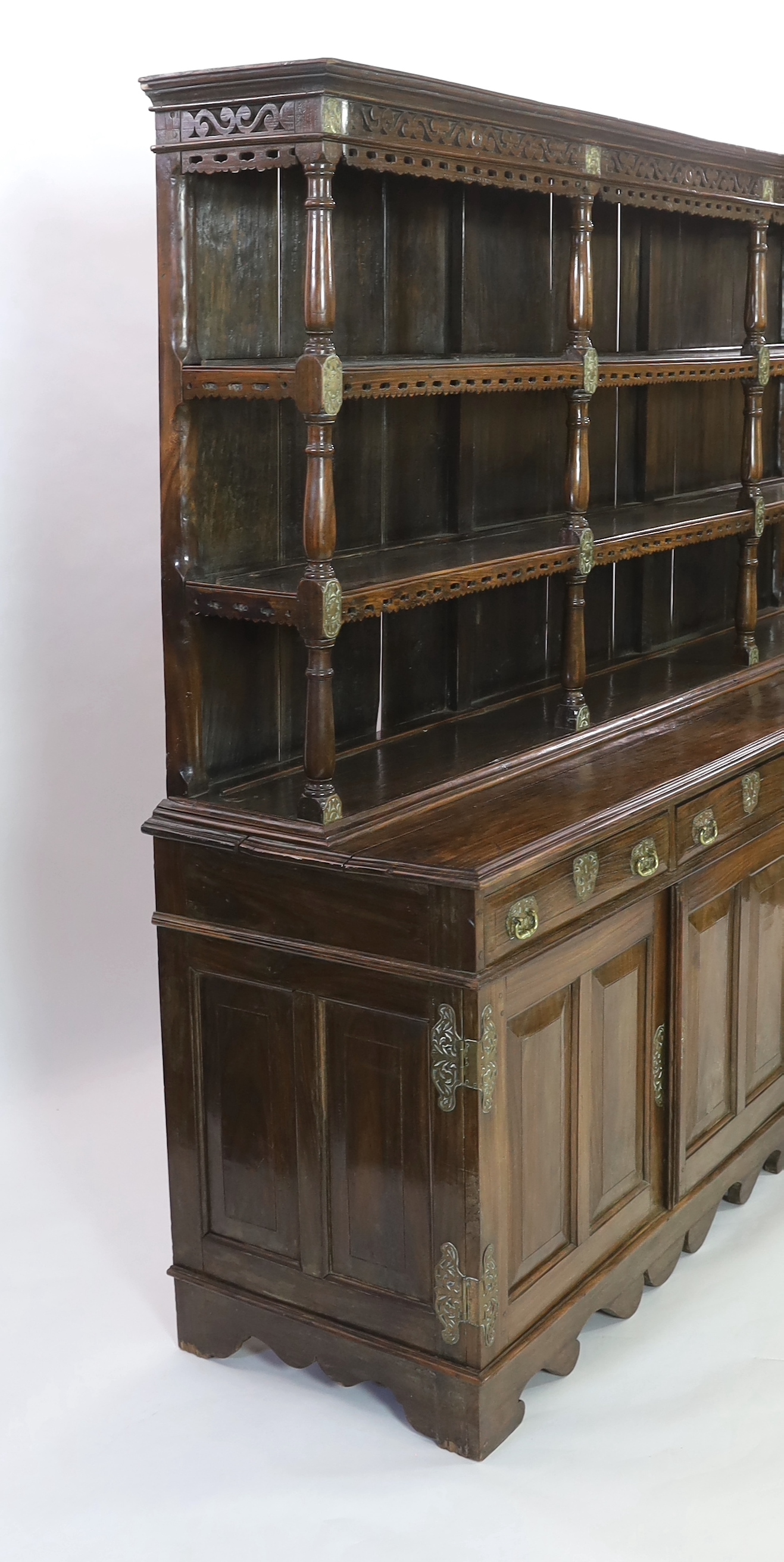 A rare Ceylonese Arts & Crafts brass mounted teak dresser